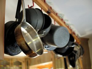 Cooking Pots And Pans Hanging In Kitchen.