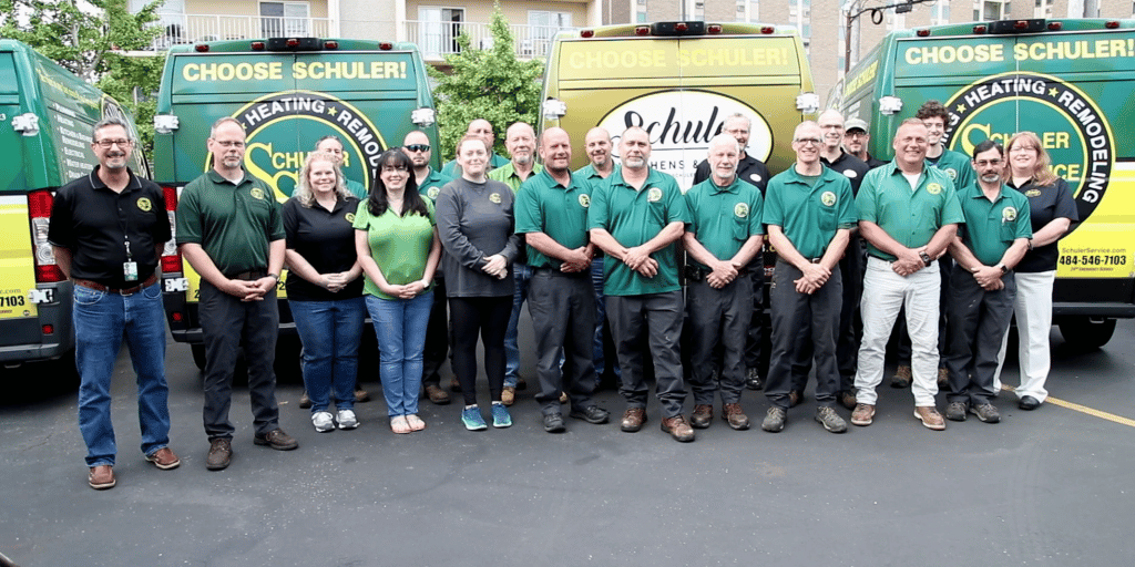 Schuler team poses in front of the storefront
