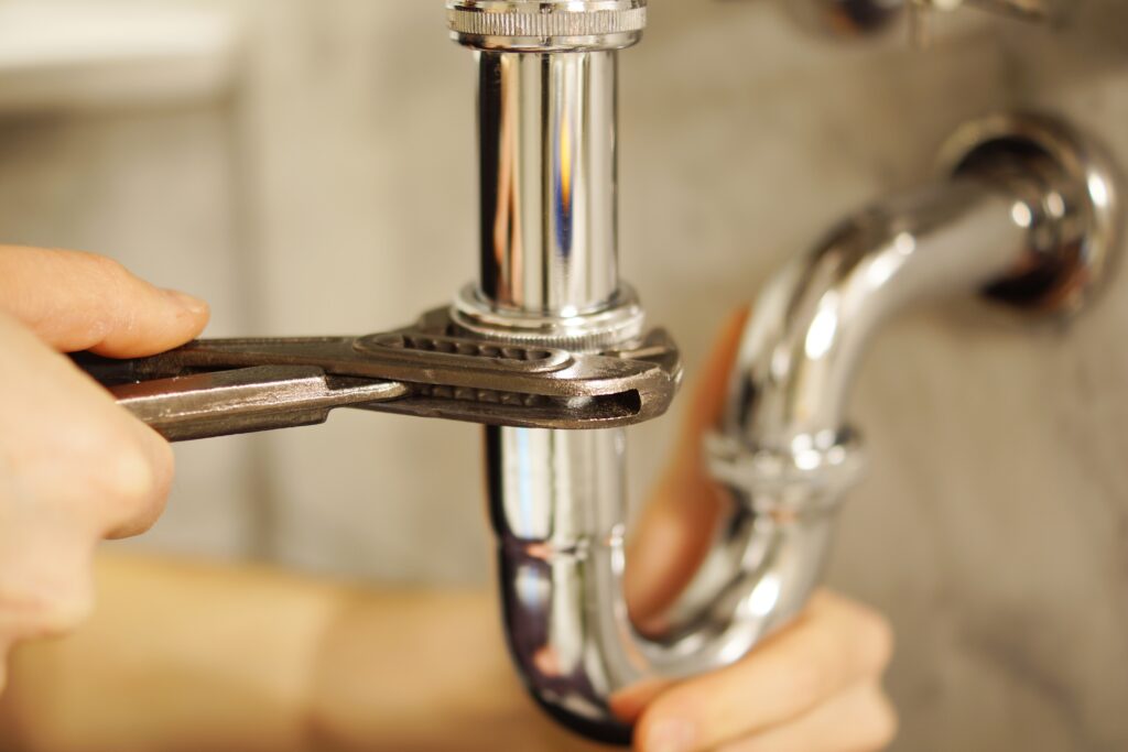 Plumber repairs and realigns pipes