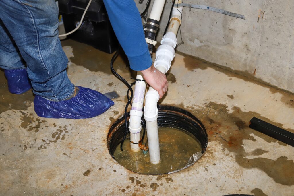 A technician is working on a sump pump repair