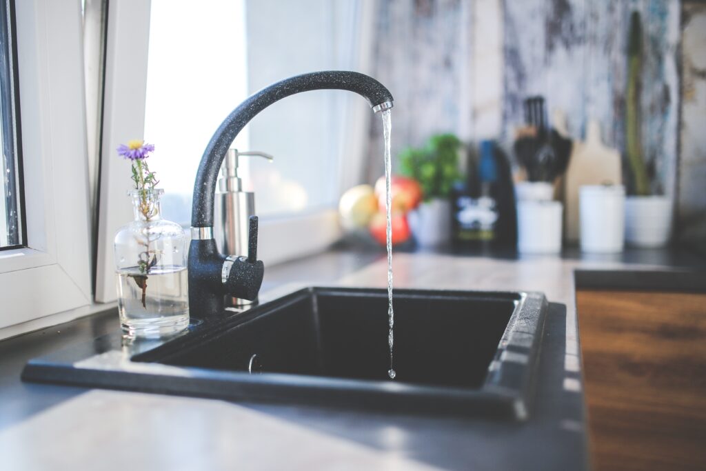 Tap running clean water from a whole-home filtration system. Photo by FreePik.